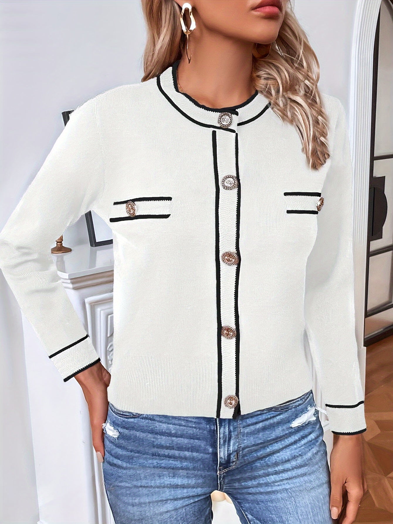 Elegant women's cardigan in white with black trim and button details for stylish layering