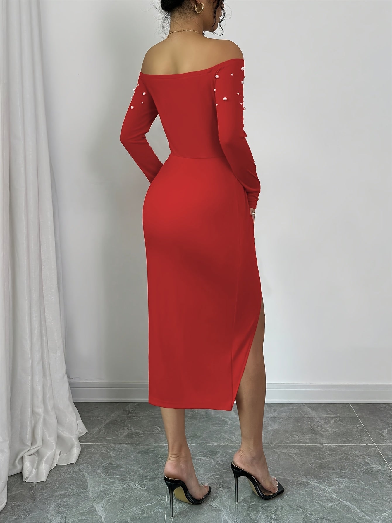 Red pearl embellished one-shoulder dress with long sleeves and side slit for elegant occasions