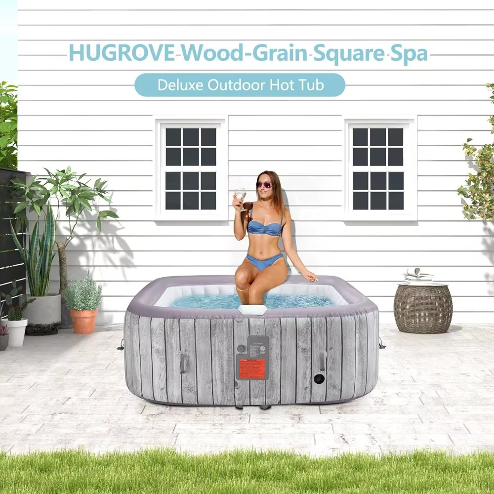 Magazaw portable inflatable hot tub with wood grain design and a woman enjoying a drink