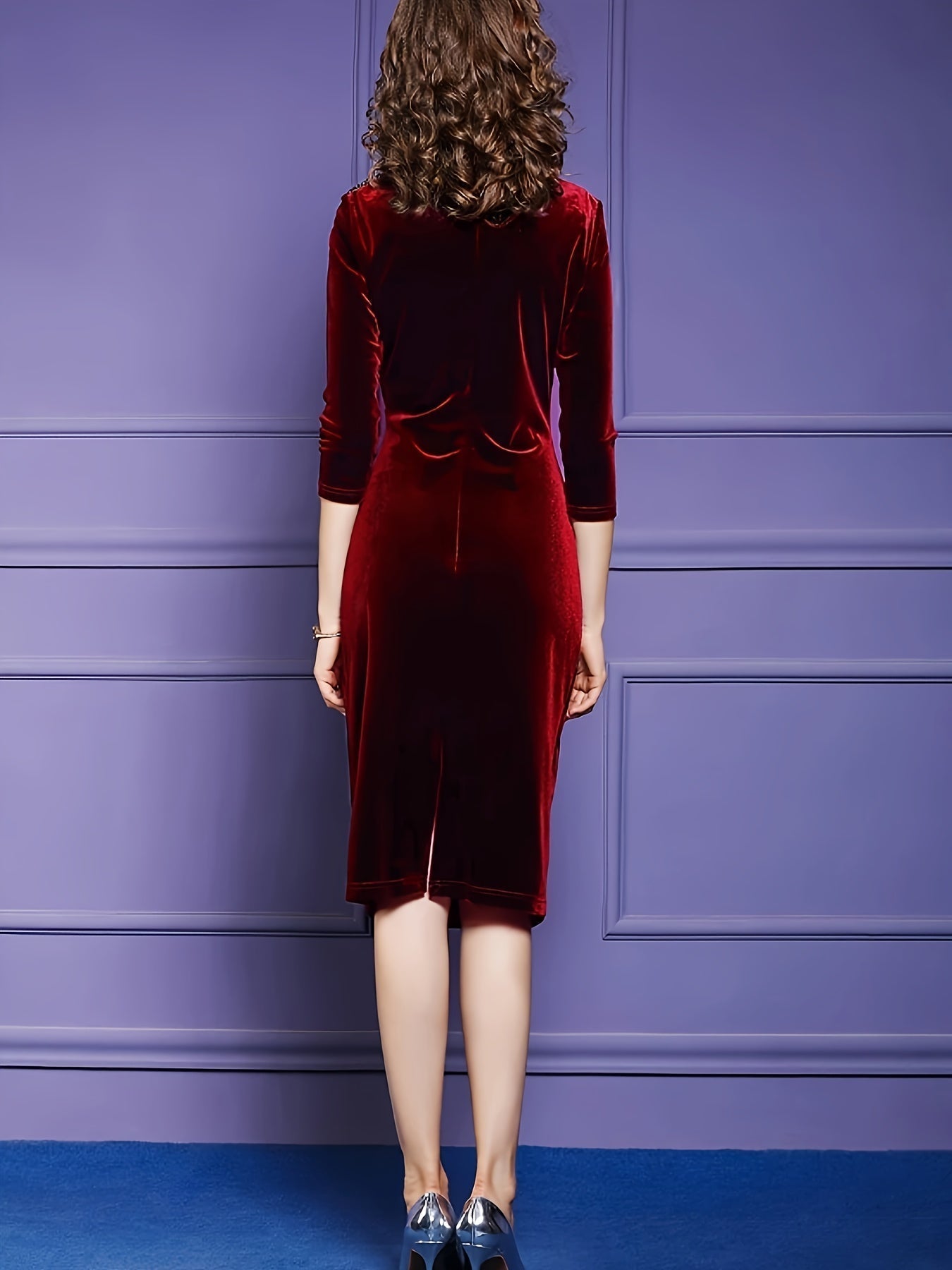Back view of Voocci red velvet midi dress with three-quarter sleeves and a fitted design