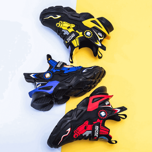 Three pairs of colorful luxury boys shoes online in black with yellow, blue, and red accents on white and yellow background