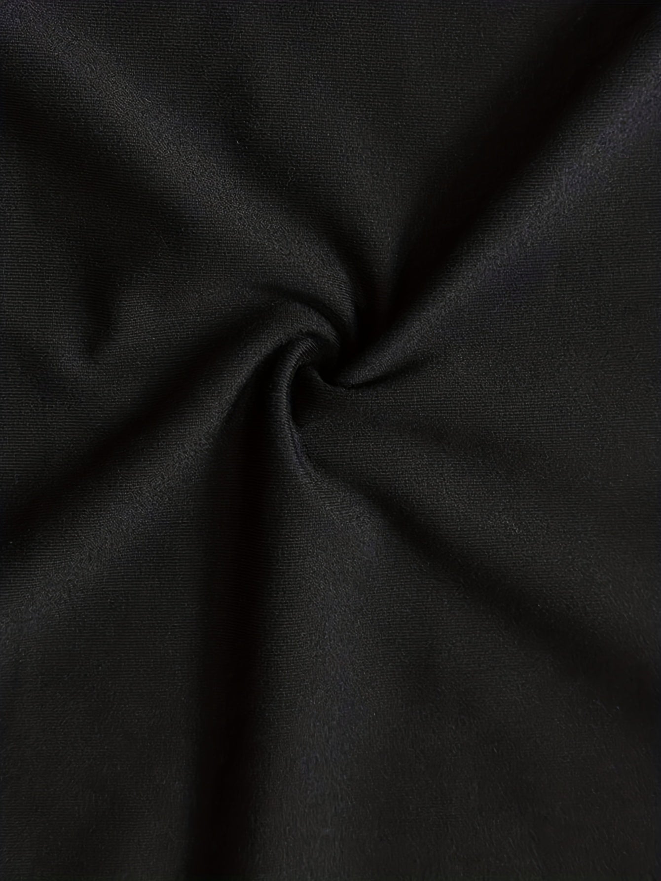 Soft fabric close-up of a cold shoulder black dress showcasing its texture and quality