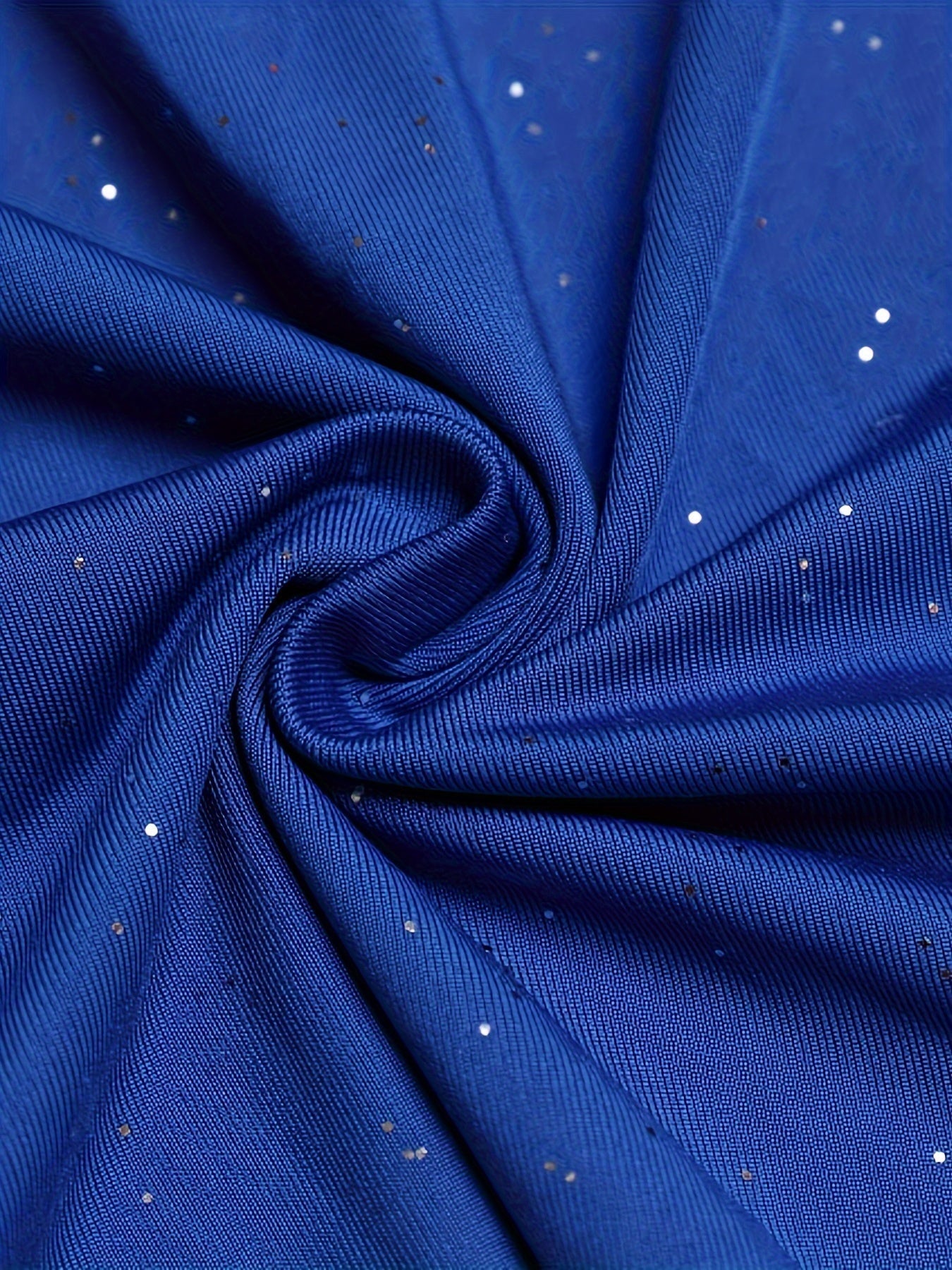 Close-up of soft blue fabric with silver sequins, not a red sequined bodycon dress