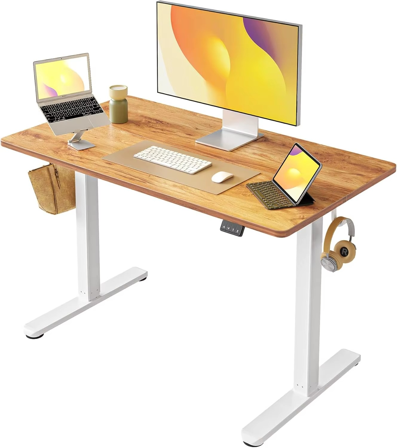 Magazaw height adjustable standing desk with a wooden finish, equipped with multiple devices and accessories