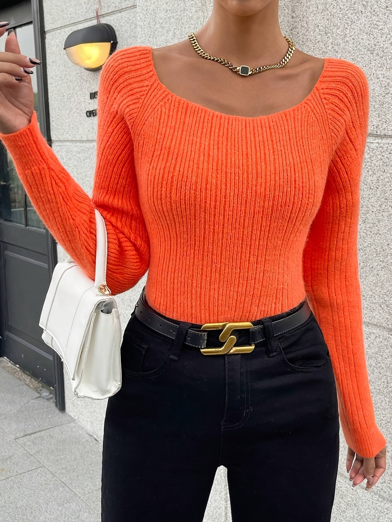 Voocci women's knitted sweater in vibrant orange with a fitted design and ribbed texture